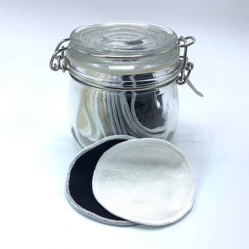 Close up of reusable natural facial rounds stored in glass jar